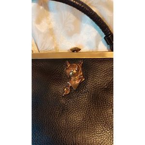 Vintage Saler hand bag black leather with brass accents. In good condition